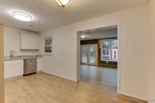 kitchen featuring dishwasher, light hardwood / wood-style floors, and white cabinetry