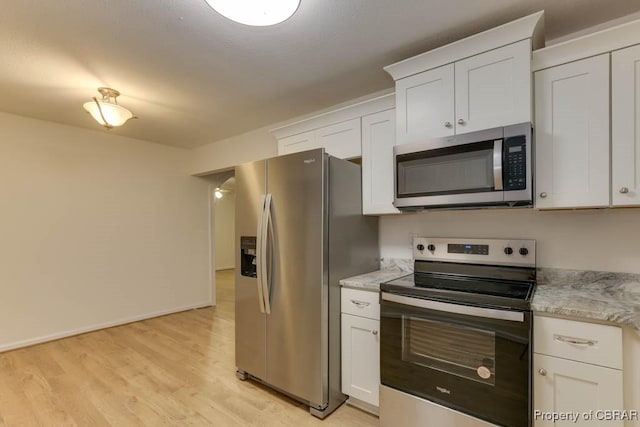 kitchen with white cabinetry, light hardwood / wood-style flooring, and stainless steel appliances