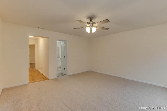 unfurnished room featuring light carpet and ceiling fan