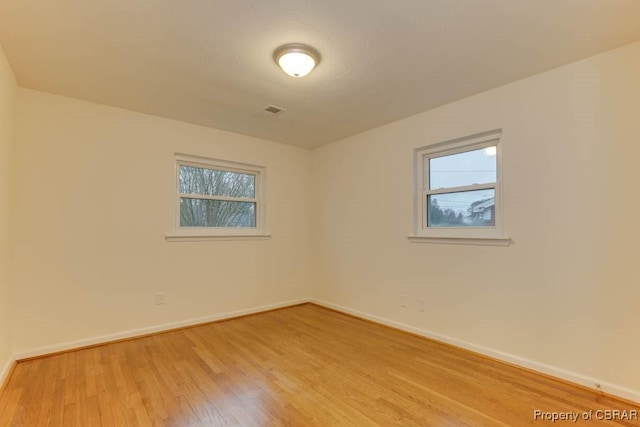 unfurnished room with light hardwood / wood-style floors