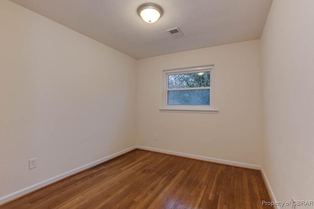 spare room featuring hardwood / wood-style floors