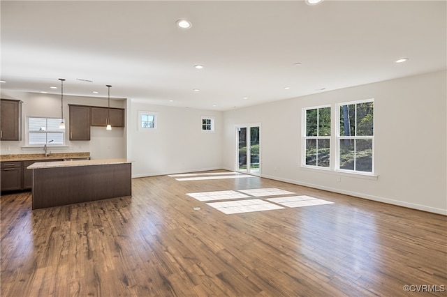 unfurnished living room with wood-type flooring