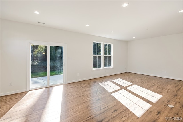 spare room featuring light wood-type flooring