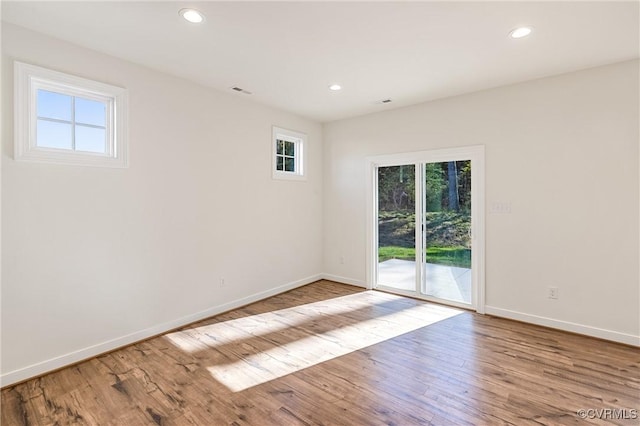 spare room featuring light hardwood / wood-style floors