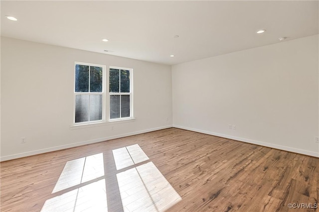 unfurnished room with light hardwood / wood-style floors