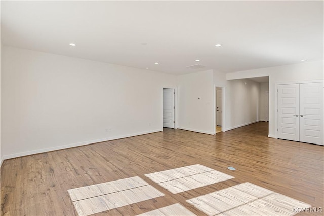 unfurnished room with light hardwood / wood-style floors