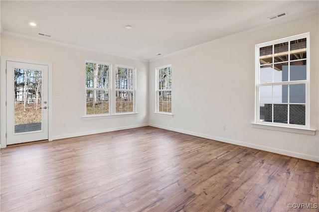 unfurnished room with wood-type flooring and ornamental molding