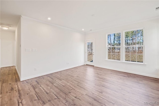 unfurnished room with light wood-type flooring and ornamental molding