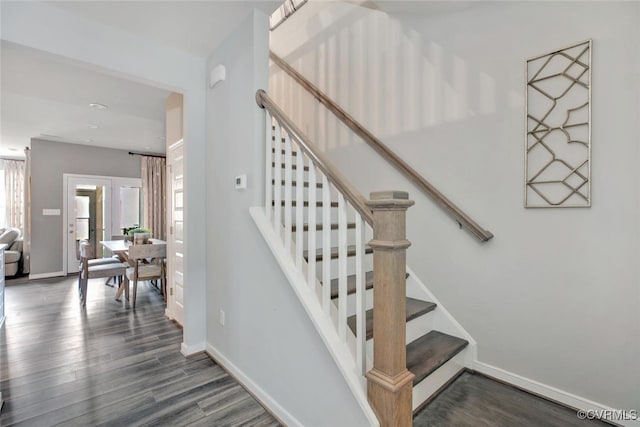 staircase with hardwood / wood-style floors