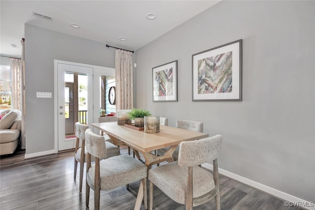 dining space featuring dark wood-type flooring