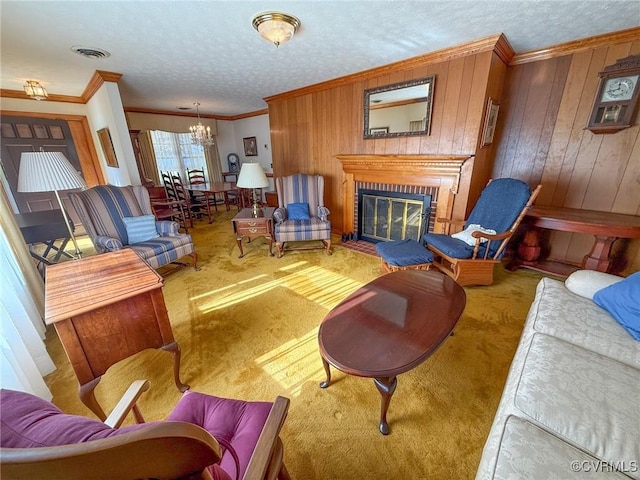 living room with wood walls, ornamental molding, and a brick fireplace