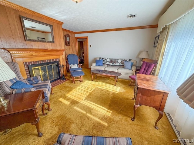 sitting room featuring crown molding, wooden walls, carpet floors, and a brick fireplace