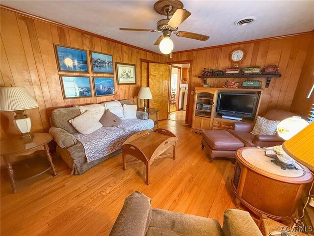 living room featuring light hardwood / wood-style flooring and wooden walls