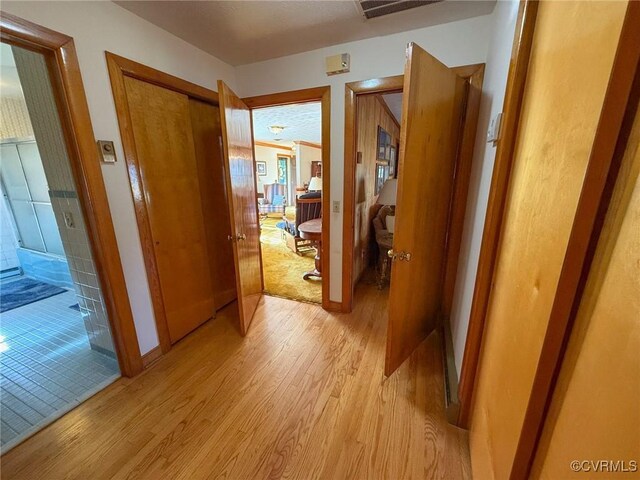 hallway with light hardwood / wood-style flooring