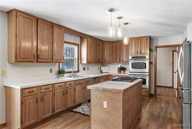 11741 Riverpark Dr, Chesterfield, VA 23838 - kitchen with a sink, light countertops, stainless steel appliances, dark wood-type flooring, and a kitchen island