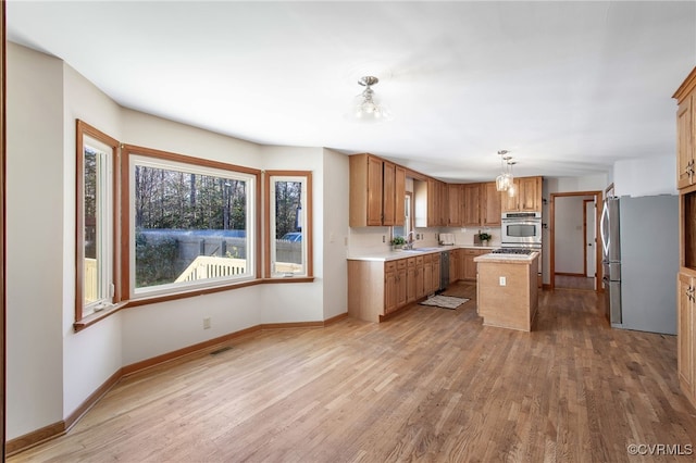 11741 Riverpark Dr, Chesterfield, VA 23838 - kitchen with a center island, a sink, light countertops, freestanding refrigerator, and light wood finished floors