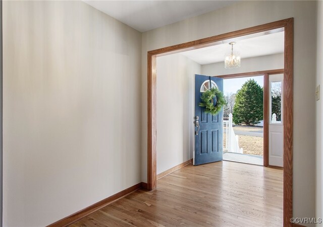 11741 Riverpark Dr, Chesterfield, VA 23838 - entryway featuring a chandelier, wood finished floors, and baseboards