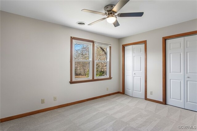 11741 Riverpark Dr, Chesterfield, VA 23838 - unfurnished bedroom featuring visible vents, baseboards, ceiling fan, multiple closets, and light carpet