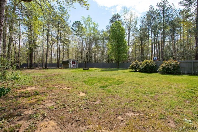11741 Riverpark Dr, Chesterfield, VA 23838 - view of yard featuring a storage shed, a fenced backyard, and an outdoor structure