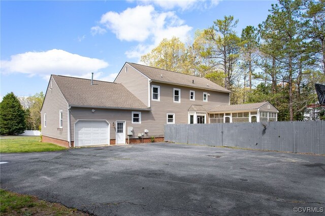 11741 Riverpark Dr, Chesterfield, VA 23838 - back of house featuring roof with shingles, a garage, and fence