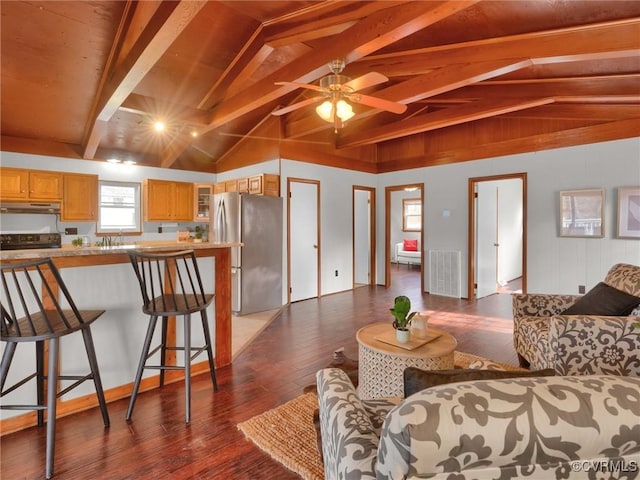 living room with dark hardwood / wood-style flooring, vaulted ceiling with beams, and ceiling fan