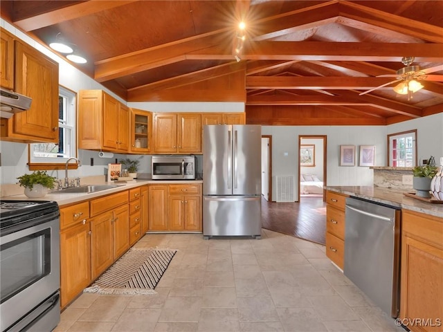 kitchen featuring sink, stainless steel appliances, light hardwood / wood-style flooring, lofted ceiling with beams, and extractor fan