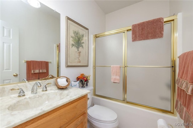 full bathroom with bath / shower combo with glass door, toilet, and vanity