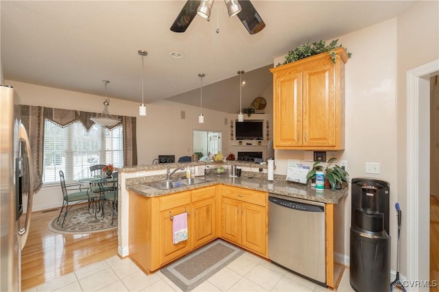 kitchen with kitchen peninsula, ceiling fan, stainless steel appliances, light tile patterned flooring, and sink