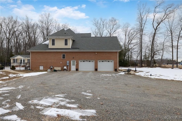 view of snow covered exterior with a garage