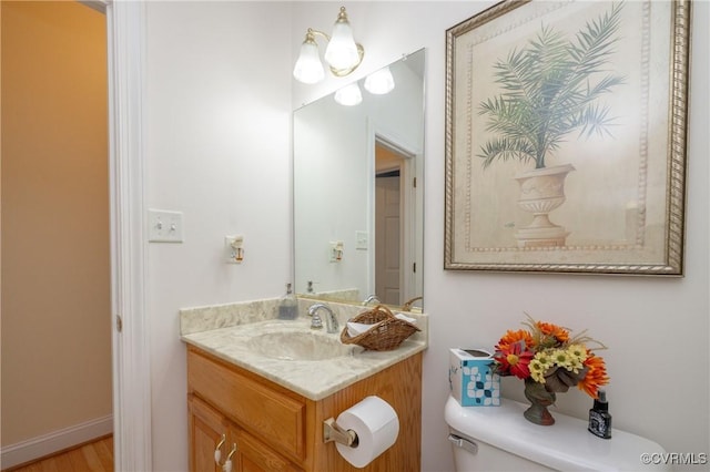 bathroom with toilet and vanity