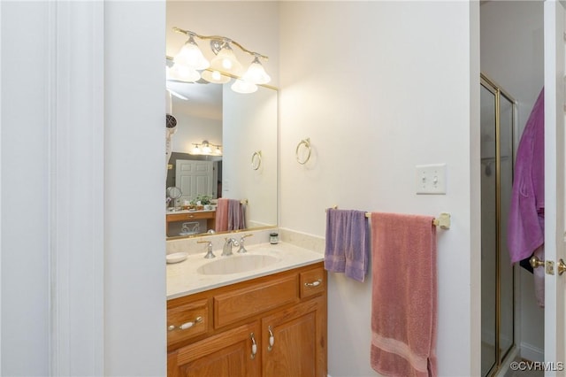 bathroom featuring an enclosed shower and vanity