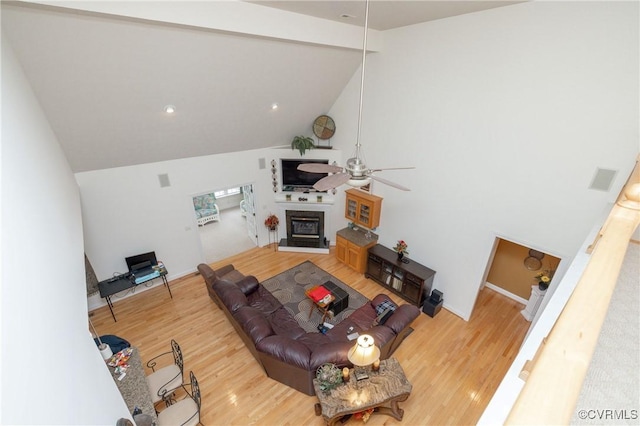 living room featuring ceiling fan, lofted ceiling with beams, and wood-type flooring