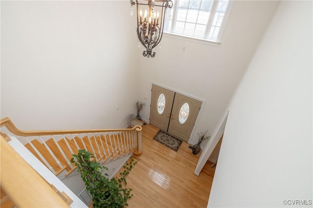 foyer with a notable chandelier and hardwood / wood-style flooring