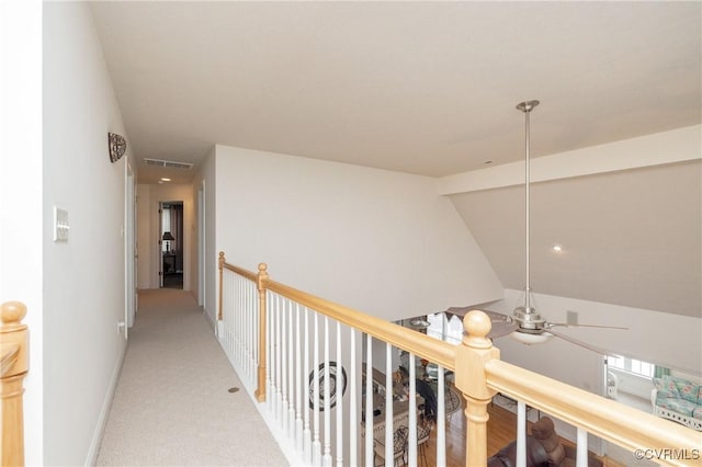 hallway with vaulted ceiling with beams and carpet floors