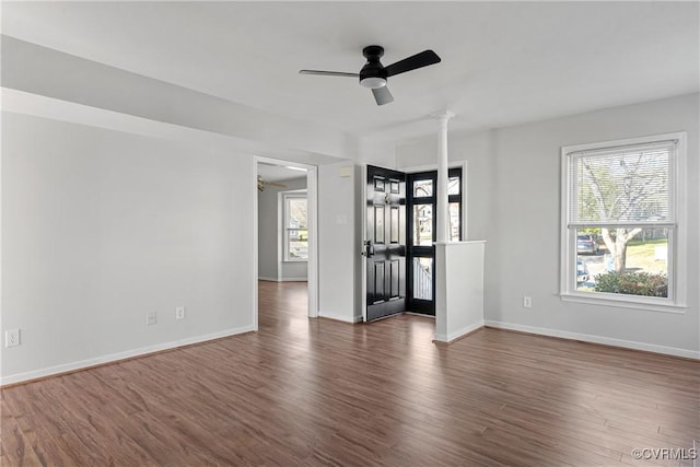 unfurnished room with ceiling fan and dark wood-type flooring