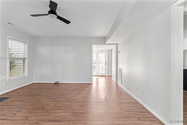 empty room with wood-type flooring and ceiling fan