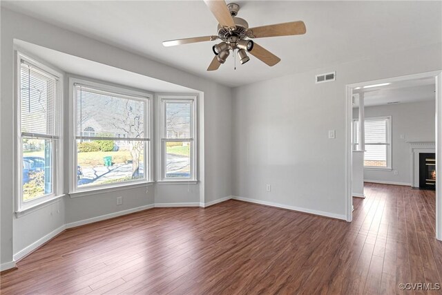 empty room featuring ceiling fan and dark hardwood / wood-style floors