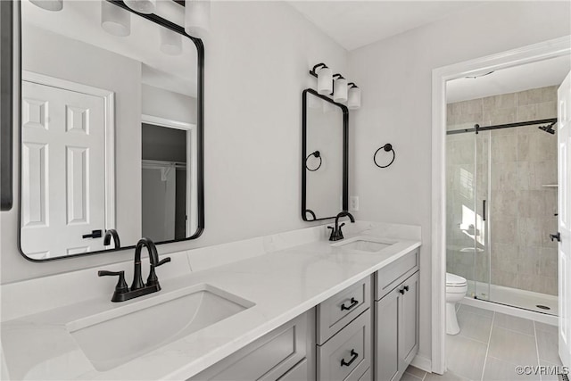 bathroom with walk in shower, tile patterned flooring, vanity, and toilet