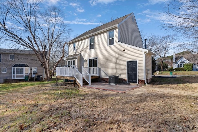 rear view of property featuring a patio, central air condition unit, a yard, and a wooden deck