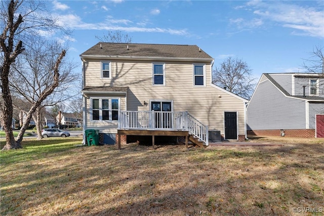 rear view of house featuring a lawn, a deck, and central AC