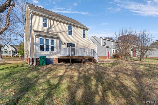 rear view of property with a yard and a wooden deck