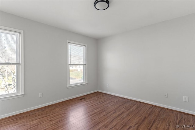 empty room featuring hardwood / wood-style flooring and a healthy amount of sunlight