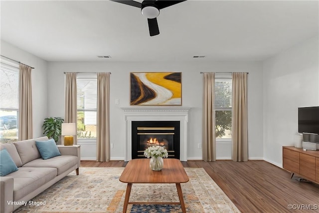 interior space with ceiling fan and wood-type flooring