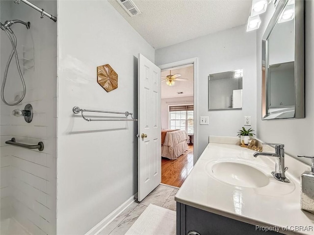 bathroom featuring a shower, a textured ceiling, and hardwood / wood-style flooring