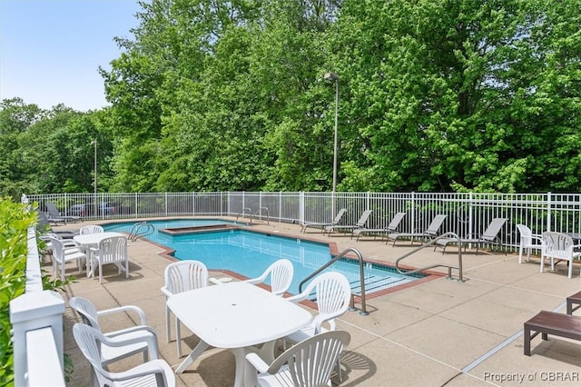 view of swimming pool featuring a patio area