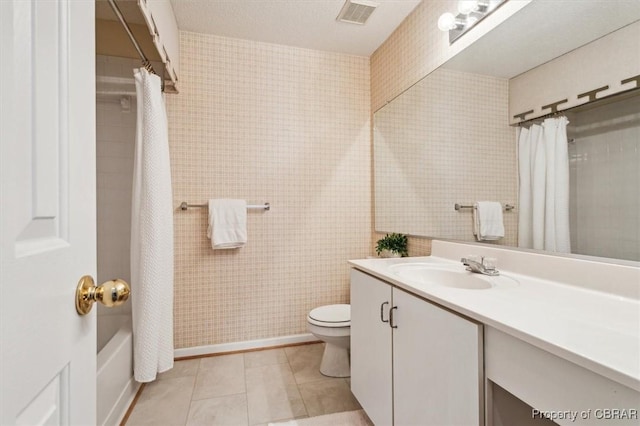 full bathroom with tile patterned floors, vanity, shower / bathtub combination with curtain, tile walls, and toilet