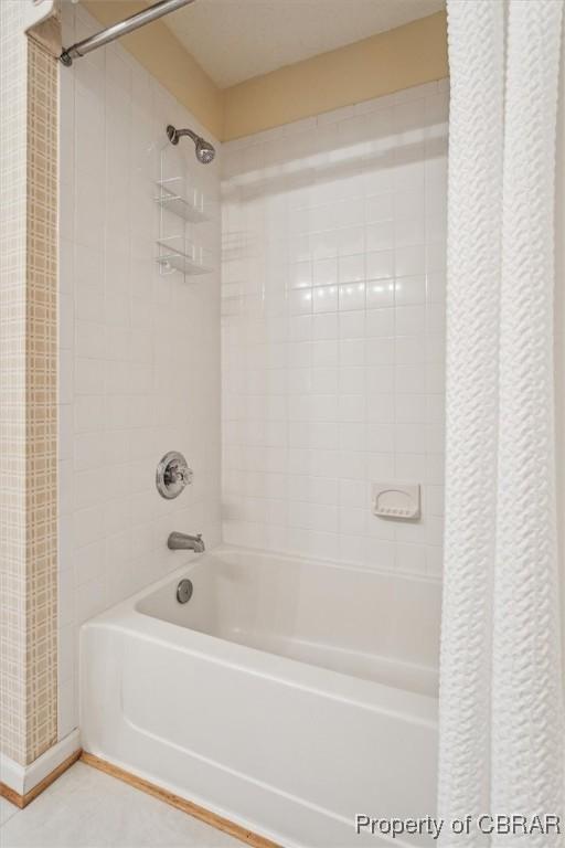 bathroom with shower / bathtub combination with curtain