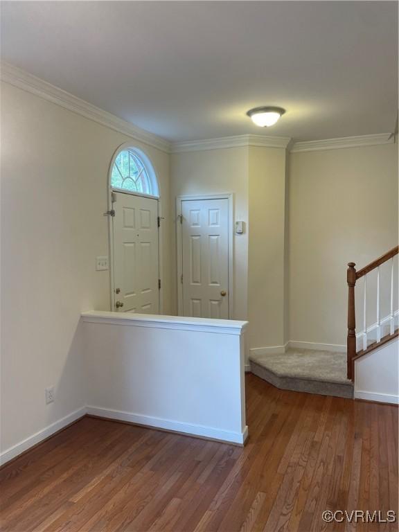 entryway featuring hardwood / wood-style flooring and ornamental molding