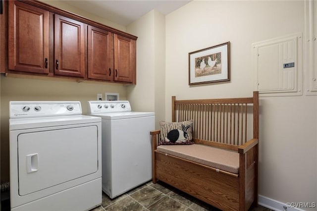 laundry area with electric panel, cabinets, and washing machine and dryer