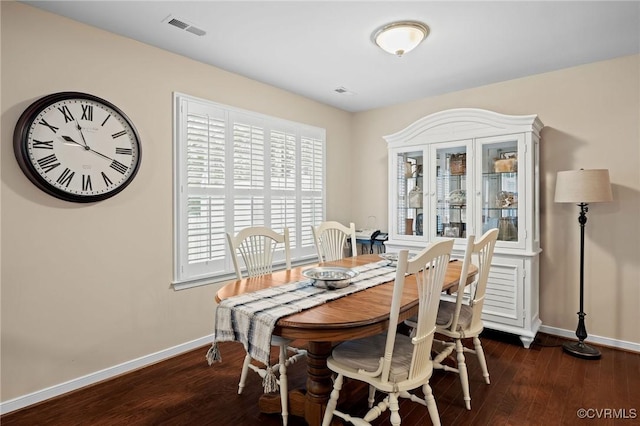 dining space featuring dark hardwood / wood-style floors